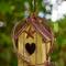 Glitzhome® 11.5" Yellow Washed with Rattan Distressed Wood Cottage Birdhouse
